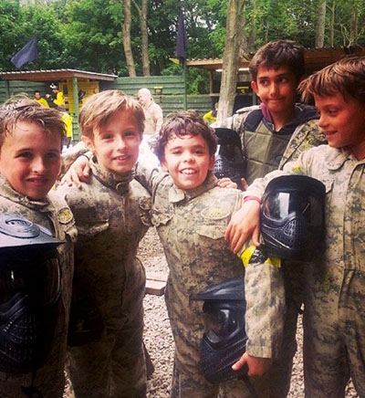 A group of young paintball players in protective kit